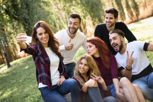 Group of friends taking selfie in urban background